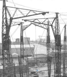 Photo of a 1930s ship building yard with tall lattice cranes