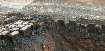 Photo showing a section through a Tar macadam road laid on cobbles