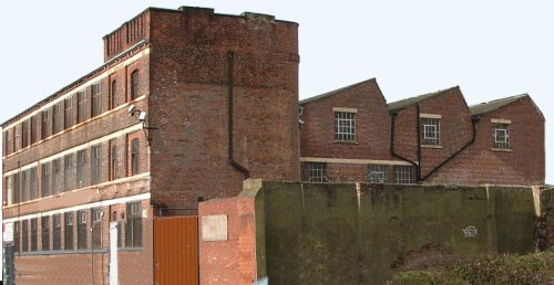 Photo showing Flat and north light roofs on a factory building